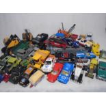 A collection of playworn die-cast and toy vehicles including Tri-ang, Tonka, ERTL, Britain's, Burago