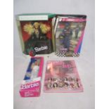 A collection of three boxed Mattel Barbie dolls, including a collector edition Nascar 50th