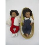 Two unboxed Sasha baby dolls including one in Moses basket and one brunette in white coat