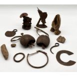 A collection of mainly African tribal items including finger knife, flint arrow heads, cow bells