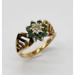 A 9ct gold dress ring set with emeralds and central diamond, total weight 3.6g