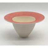 A porcelain studio pottery bowl of conical form with pink rim and impressed mark to base possibly TG