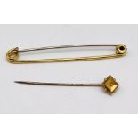 A 15ct gold tie pin (missing seed pearl) weight 0.8g along with a gold plated safety pin