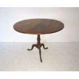 Antique tip-up table on tripod base.