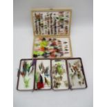 A collection of fishing flies and lures in storage cases