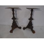 A pair of cast iron table bases, the base formed of stylised dolphins