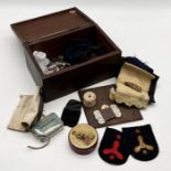 A wooden sewing box containing cotton reels, buttons, needles etc including two Royal Australian