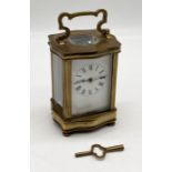 A French carriage clock with Douchine style brass case - hinge on door needs some restoration