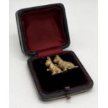 A vintage gilt brooch of two Scottie dogs in leather case