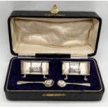 A cased set of silver salts with blue glass liners and salt spoons- 1 spoon replaced