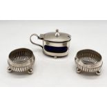 A pair of hallmarked silver salts along with a lidded mustard pot with blue glass liner