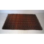 A red ground Eastern rug, approximately 216cm x 135cm.