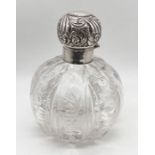 A large silver topped scent bottle with cut glass decoration to the bowl, height 15.5cm