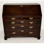 A Georgian oak bureau with five drawers on bracket feet with fitted interior