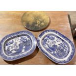 Two blue and white meat platters along with a wooden painted charger