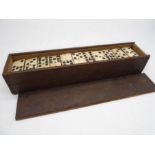 An antique bone double nine domino set (55 pieces) in wooden case