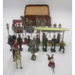A collection of vintage lead toys including military figures, road signs, petrol pumps and milk