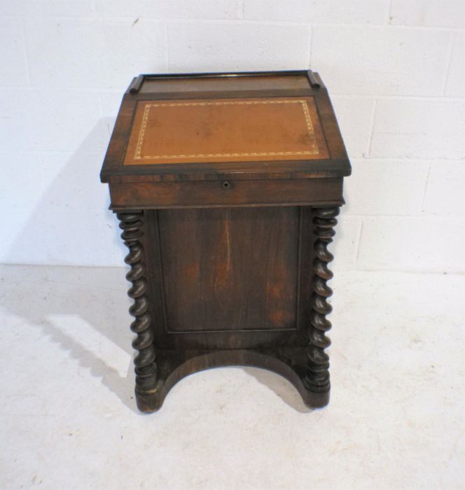 A turn of the century rosewood davenport, with barley twist supports - one caster missing on back,