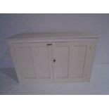 A vintage white painted two door cupboard - Height 108cm, Length 172cm, Depth 47cm
