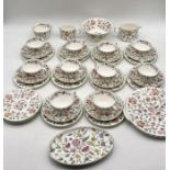 A Minton Haddon Hall part tea set including ten trios, two creamer jugs, two bowls, small oval