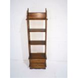 An Edwardian style set of shelves with two drawers under, length 33cm, depth 19cm, height 112cm.
