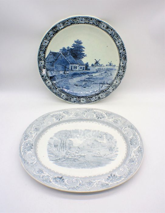 A blue and white ceramic Boch Delfts charger along with a meat platter.