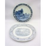 A blue and white ceramic Boch Delfts charger along with a meat platter.
