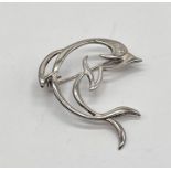 A 925 silver brooch in the form of a stylised dolphin