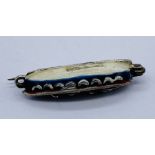 A hallmarked silver and enamelled brooch in the form of a lifeboat