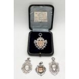 An unmarked silver and gold medallion in fitted case along with three silver medallions