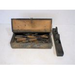 A vintage wooden toolbox containing various tools including wood planes, chisels etc - some