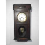 A 1920s wall hanging oak clock.