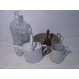 An assortment of glass, enamelware and a bell including a Crisa glass Mexican carboy.