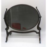 An Edwardian mahogany oval toilet mirror.