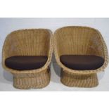 A pair of wicker tub chairs.