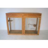 An animal cage with two doors and two drawers, length 183cm, depth 56cm, height 124cm.