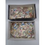 Two shoe boxes of loose stamps