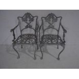 A pair of painted metal bistro chairs