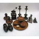 A coffee grinder along with two pairs of wooden candlesticks, flat irons etc.