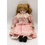An Ernst Heubach bisque headed antique doll marked with a horseshoe "Made in Germany" 1900 13/O