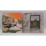 Two 12" vinyl records by Led Zeppelin - 'Houses Of The Holy' on green and orange labels with