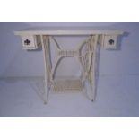 A painted table converted from a Singer treadle sewing machine stand