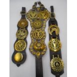 Three sets of vintage horse brasses on leather straps