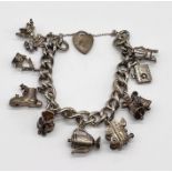 A hallmarked silver charm bracelet with a collection of charms (some articulated) weight 67g