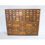 An oak Art Deco industrial chest of eighty five drawers, length 168cm, depth 28cm, height 140cm.