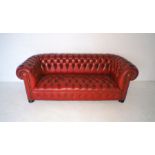 A red leather Chesterfield, with button detailing to back and seat, length 209cm, depth 88cm.