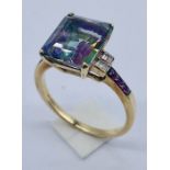 A 9ct gold mystic topaz ring with diamond baguette setting