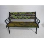 A weathered garden bench with cast iron ends