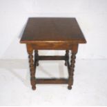 An oak occasional table with bobbin turned supports.