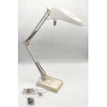 An Anglepoise lamp with inset magnifying glass